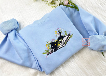 Embroidered Cute Cat Lying On Book With Flower Sweatshirt | Flower With Cat Embroidered Hoodie | Book Lover T-Shirt | Crew Neck Sweatshirt